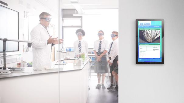 A school laboratory with a teacher speaking to students, a LV-Tron display showing the rules of the lab is nearby