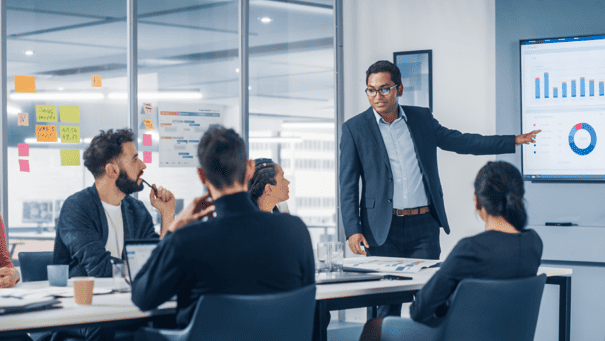 A modern, technology-enhanced meeting room with smart panels, executive room signage, and video conferencing equipment for an efficient and connected meeting experience.